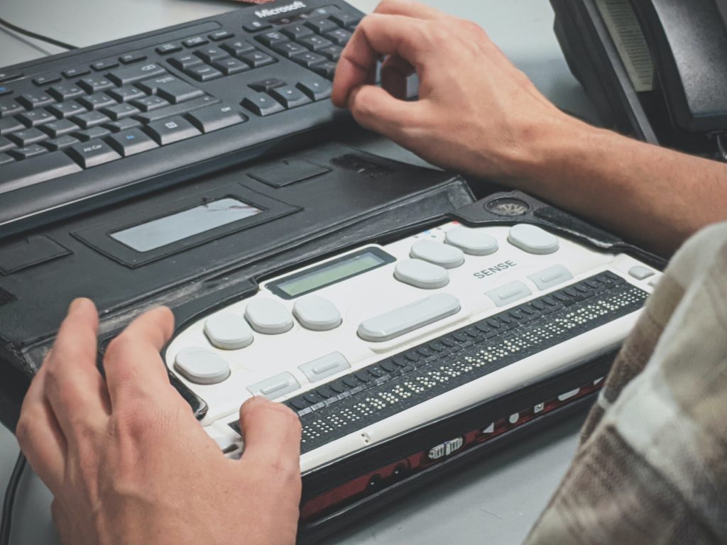 Person Using a Braille Screen Reader With Computer Keyboard
