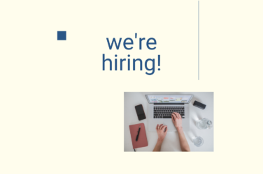 Text says: "we're hiring." A person is working on a laptop in the background.
